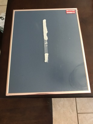 A blue chalk surface with a thin rose gold frame. Obviously on clearance at Target--and I couldn't get the sticker off the center without ripping open the packaging.